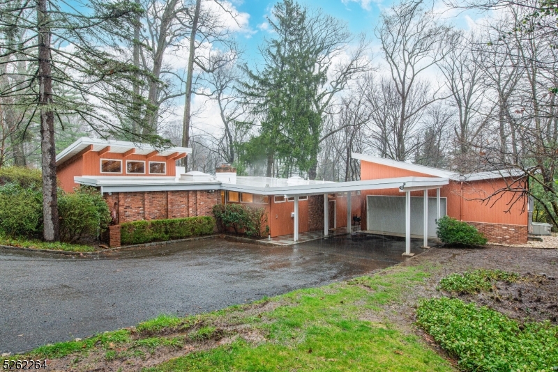 Welcome to this stunning and versatile mid-century modern masterpiece. Situated on nearly half a wooded acre off a private dead-end road.