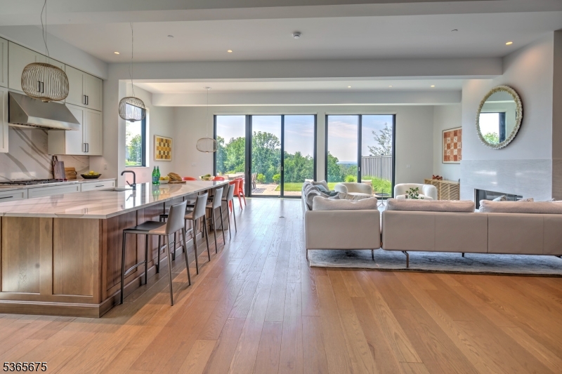 Floor-to-ceiling contemporary Pella windows and doors open to an expansive terrace with stunning views of the Somerset Hills and Pendry Natirar. Wide plank, white oak flooring. Large center island with Cambria quartz waterfall edge countertop.