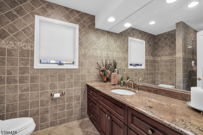 1st Flr Ensuite Bath Tiled bath, large granite vanity