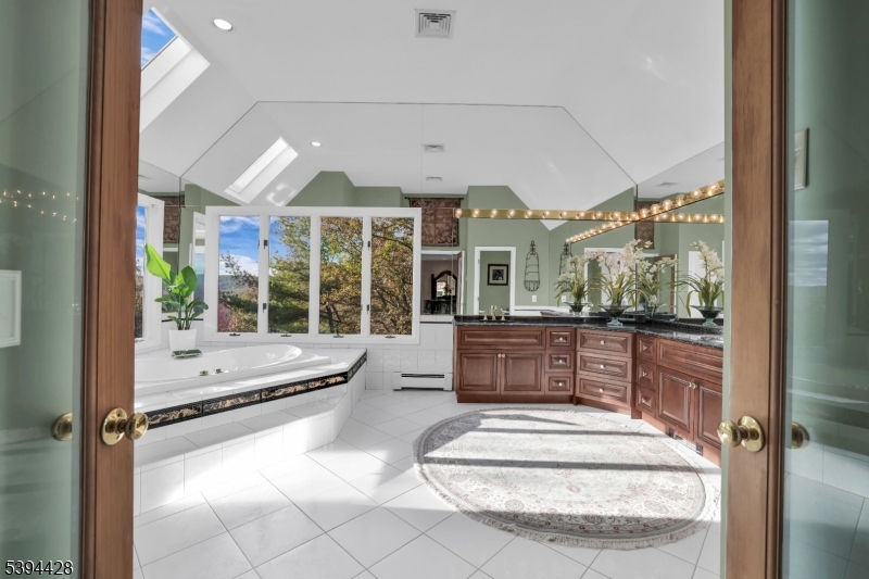 Primary Bath Jetted tub, shower stall, dual sink granite vanity. Mountain views.