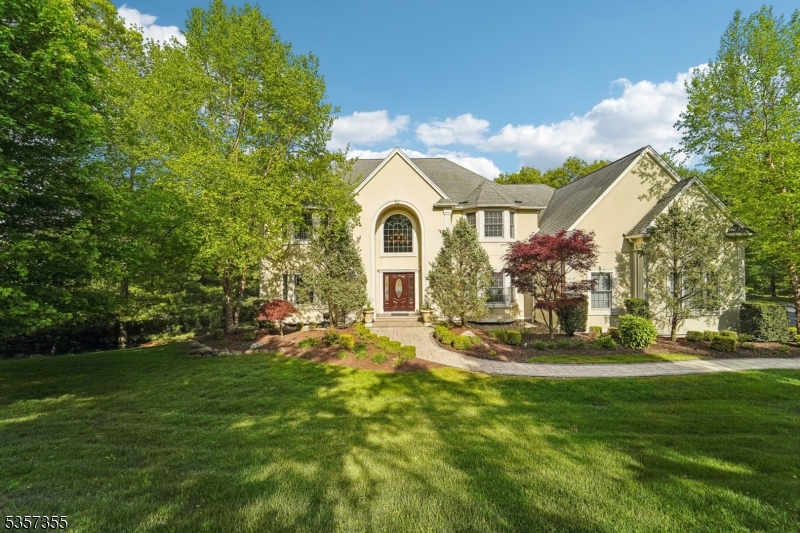 Inviting paver path sets the stage for this elegant Colonial home.