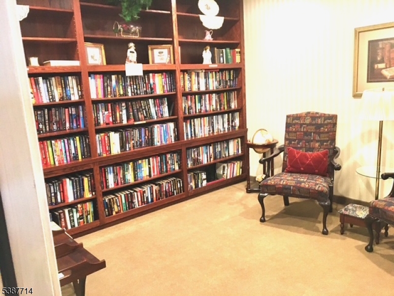 Library One of many amenities in the building. Stop by for a book or relax and read in this comfortable space.