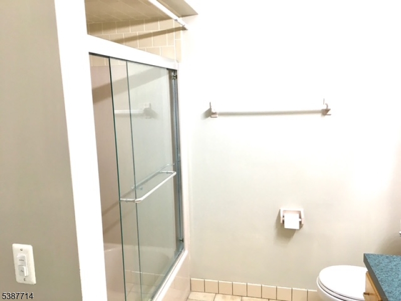 Full Bath Large bathroom, directly across from bedroom with a tub shower, new toilet and large vanity for storage.
