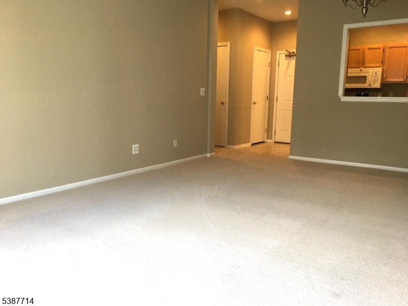 Living Room View of this large LR/DR flexible space which has new carpeting and freshly painted walls.