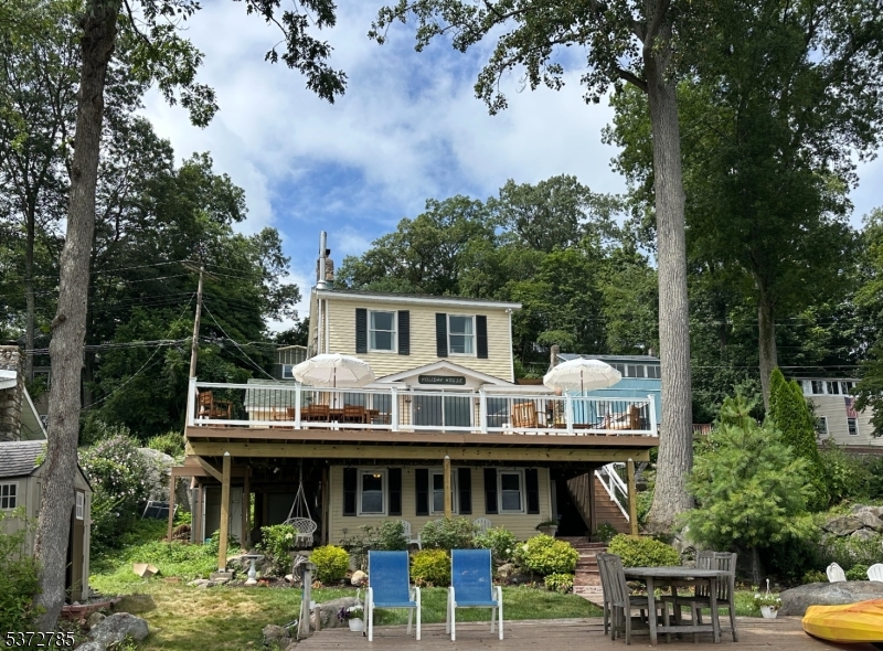 View of the house from the lake. Enjoy the wrap around deck and awesome lake views from yard.