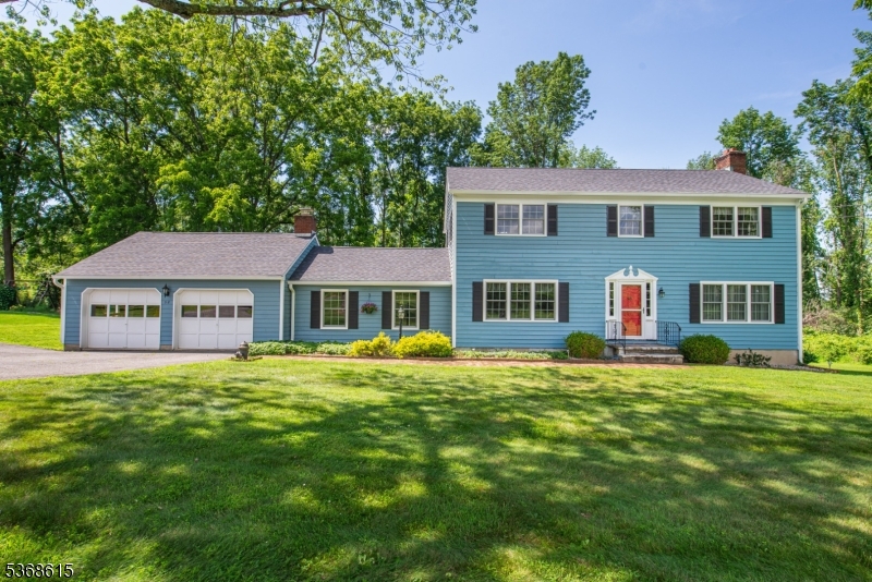 Expanded 2-story colonial home featuring a converted garage that now serves as a spacious family room, along with a newly added oversized two-car garage. The main house showcases freshly painted cedar siding. Conveniently located within walking distance