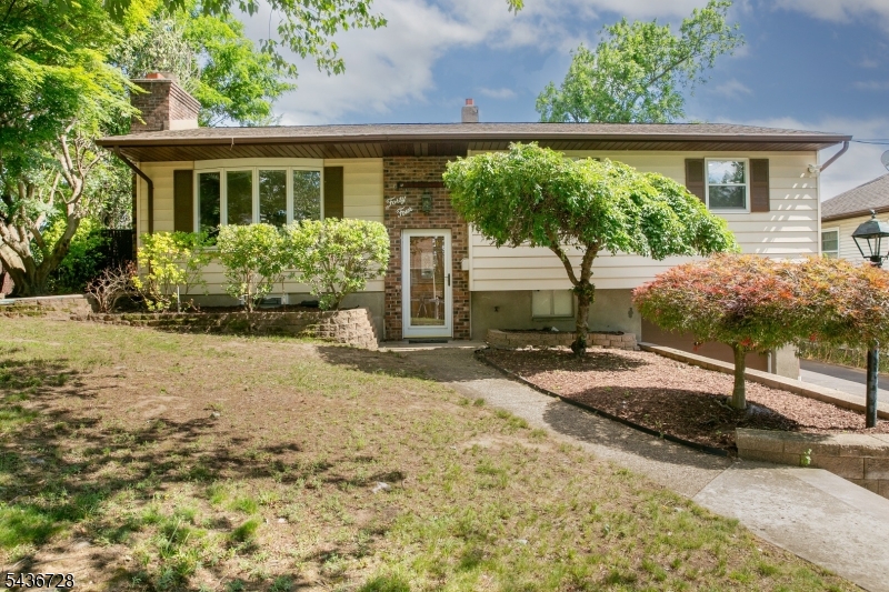 Beautiful Bi-Level home set on a landscaped lot featuring mature trees, attractive curb appeal, brick accents, an attached garage, & a welcoming entryway. Established plantings & thoughtful hardscaping create a warm first impression.