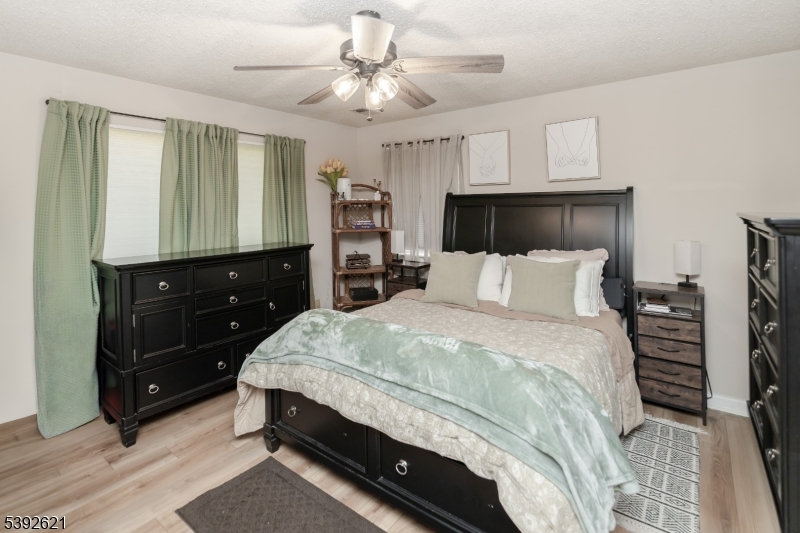 Primary Bedroom Ceiling fan, walk in closet, neutral decor.