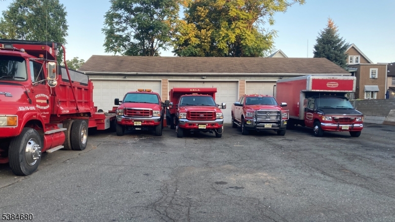 Wide apron opens to expansive parking and building with three 10x16 garages opening to the 1,500 sq ft building with 12 foot ceiling. Fully fenced secure property