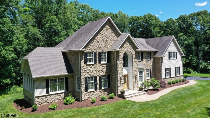 Welcome! This stunning, stone front colonial is located in a cul-de-sac setting in Long Valley, with top rated schools.