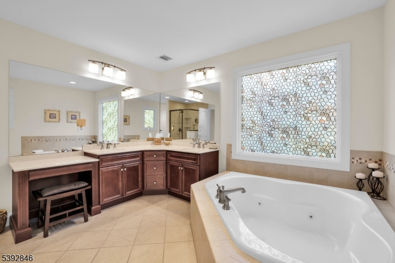 Primary Bath Dual vanity, dressing area, jetted tub, tile flooring