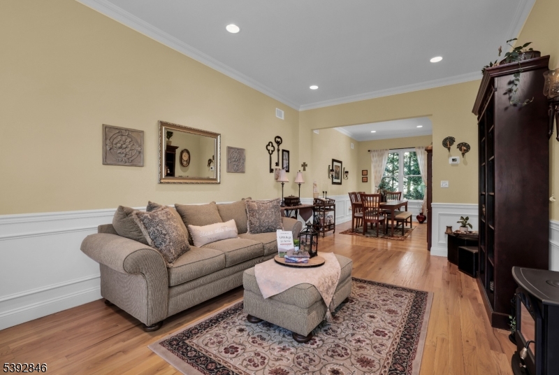 Formal Living Room Wood floors, crown molding, recessed lighting