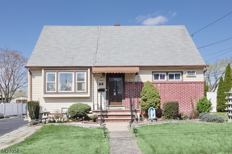 Charming Cape Cod with brick and sliding exterior, covered entry, and beautiful maintained landscaping offering great curb appeal.