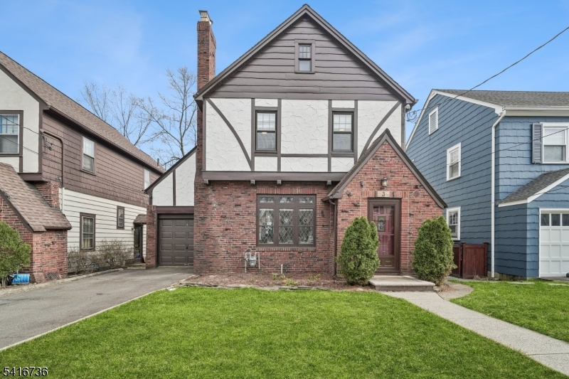 Front Exterior Classic Brookdale Tudor with gorgeous brickwork and stained glass windows