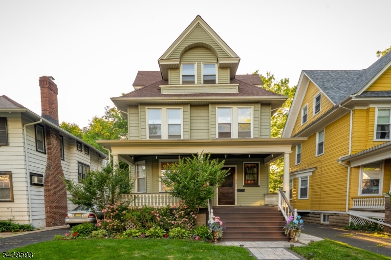 Front Charming single-family home with inviting front porch and classic architectural details.