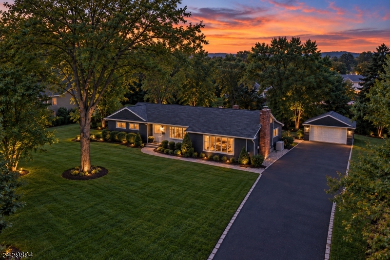 A large front yard and a long drive way.