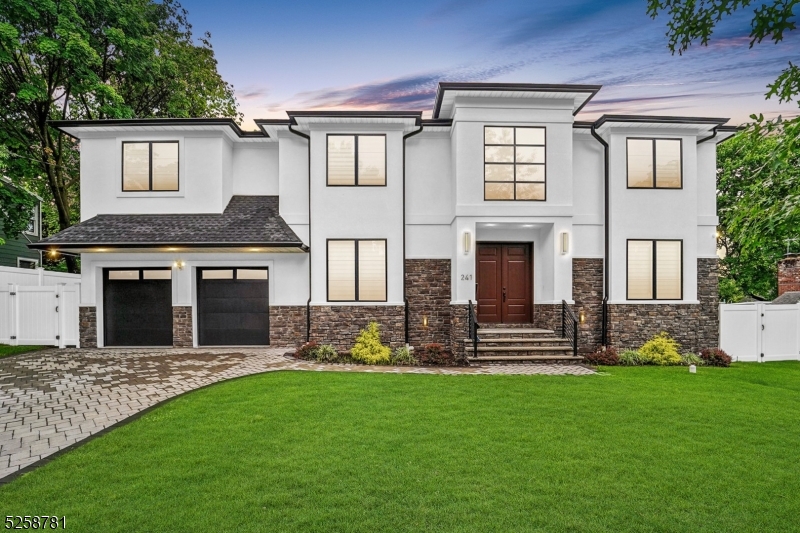 Beautiful White Stucco with Black window trim and stone accent