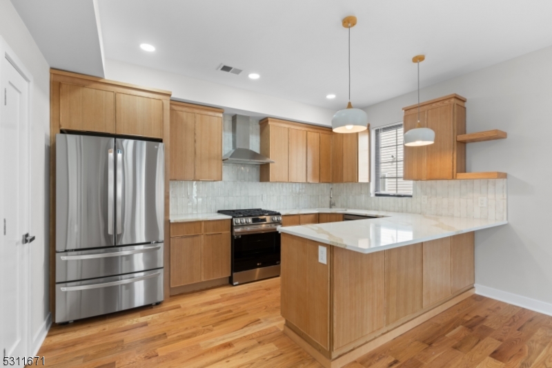 Quartz countertops & warm wood cabinets