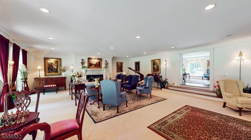 This massive room boasts a gas fireplace & 3 sets of double french doors. Carpet keeps the cozy feel. There is also a wet bar room with great storage. Open to the dining & living rooms for amazing flow.