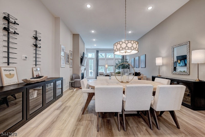Dining Room Elegant open-concept living and dining area showcases wide-plank flooring, designer lighting, and sophisticated finishes throughout. A spacious layout ideal for entertaining, everyday living, and creating memorable gatherings.