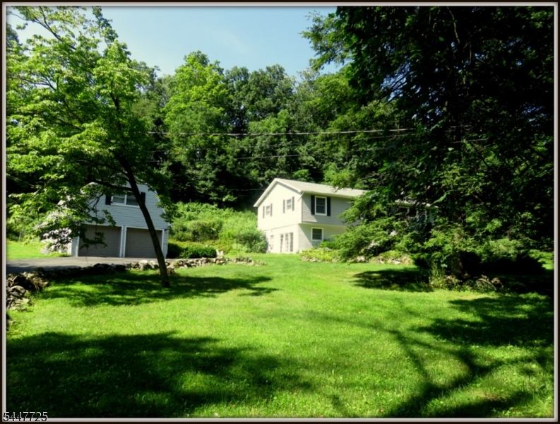 Private Home on 1.67acres hidden from the road by a stand of mature trees which provide complete privacy