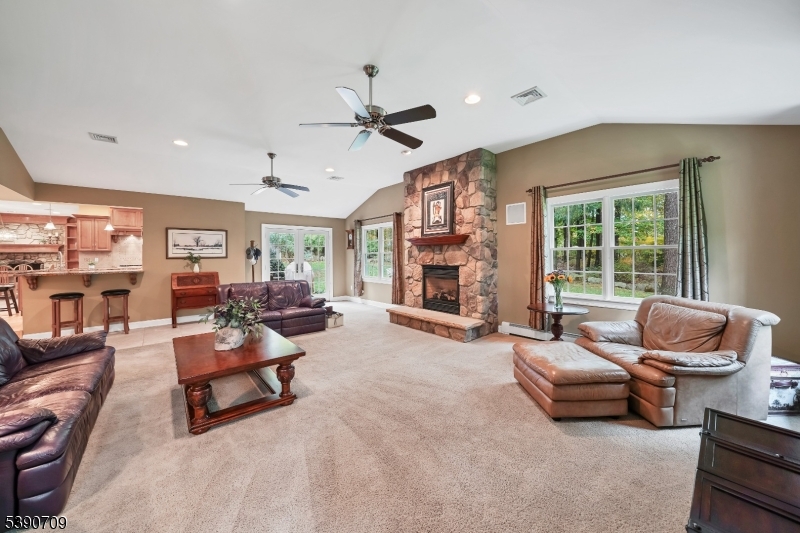 Great Room Stone fireplace and doors to back deck/patio