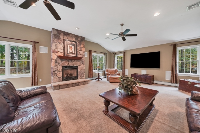 Great Room Stone fireplace and doors to back deck/patio