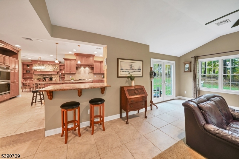 Kitchen / Great Room Peninsula with counter seating and doors on right to back deck/patio