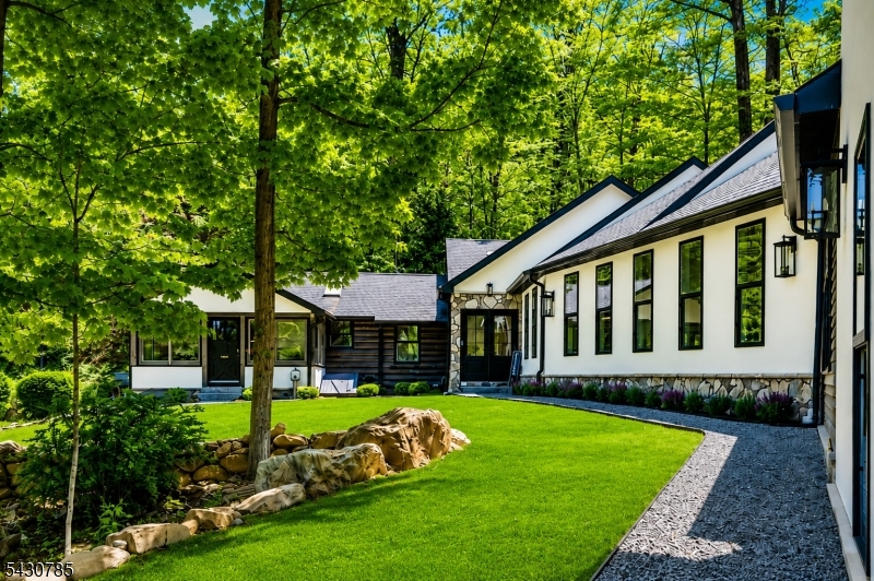 A beautiful front view highlights the homes welcoming entrance and standout presence. Enhanced with a digitally improved lawn that highlights how the freshly seeded grounds will soon flourish.