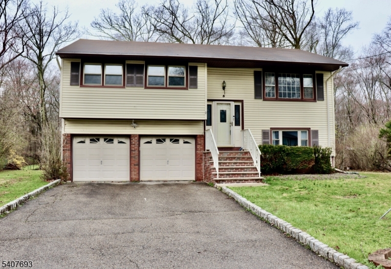 Front Wonderful bi-level home has an oversized 2-car garage with storage and flat driveway