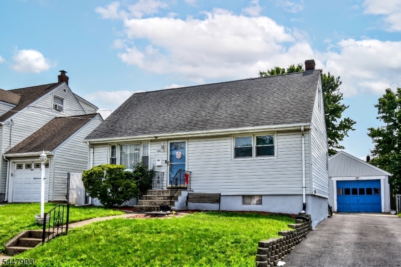 Charming Cape-style home with private driveway leading to the detached garage