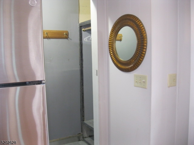 Entrance to the coat closet and utility room with a newer washer and dryer.