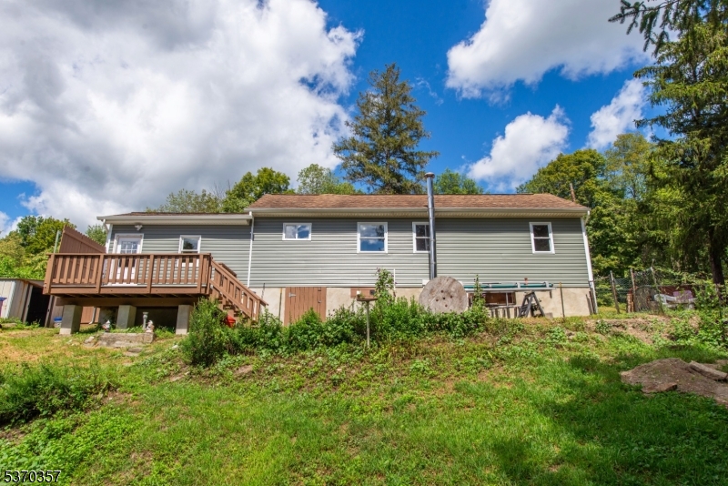 A one-quarter-acre property provides numerous expansion opportunities. It includes an outbuilding and ample open space.