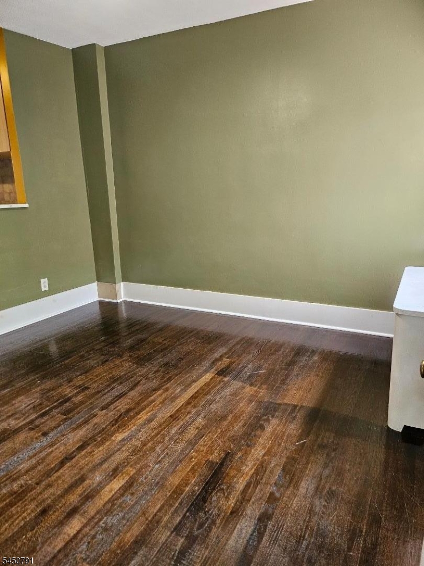 2nd FL Living Room Front door entrance via. living room radiator by window.