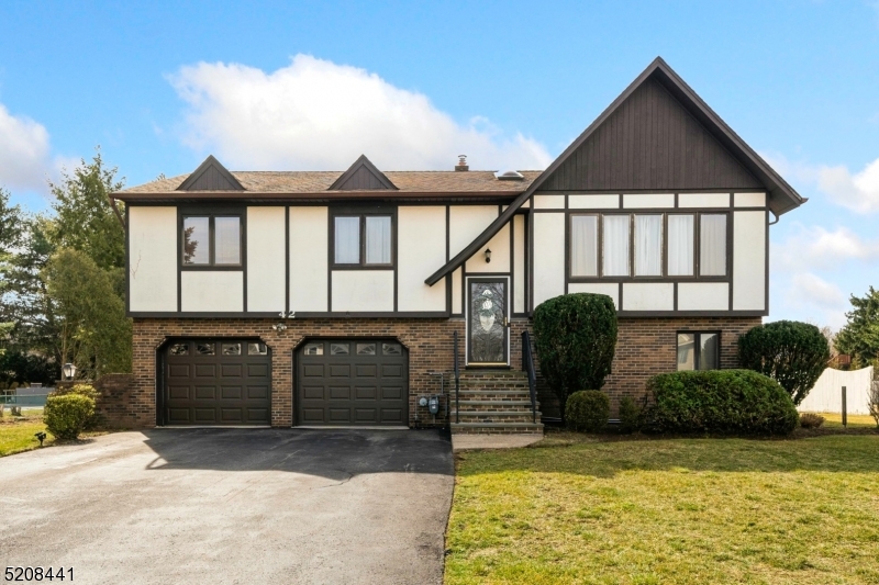 Tudor style Bi-level perched on one of the best streets in town!