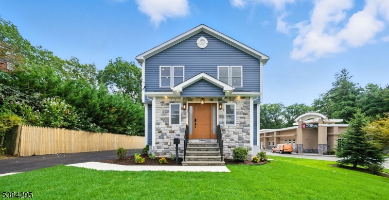 Stunningly renovated home with impeccable curb appeal. Featuring a new facade with stone accents, a landscaped front yard, and a fresh driveway.