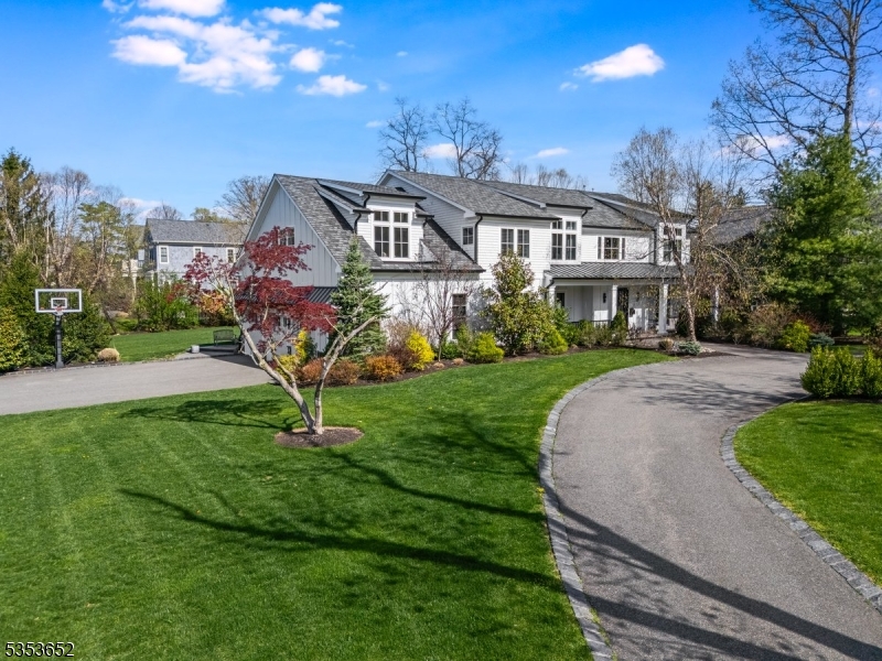 Framed by sweeping lawns and a circular driveway, 26 Coventry Road makes an unforgettable first impression. Crisp architectural lines, expansive windows, and black metal roof accents hint at the modern sensibility that runs throughout the home.