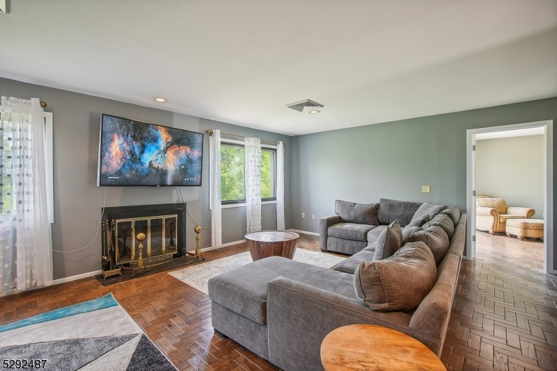 Large bright windows & lovely wood burning fireplace