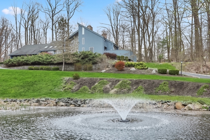 Enjoy the tranquility of your own private pond in this estate-like setting