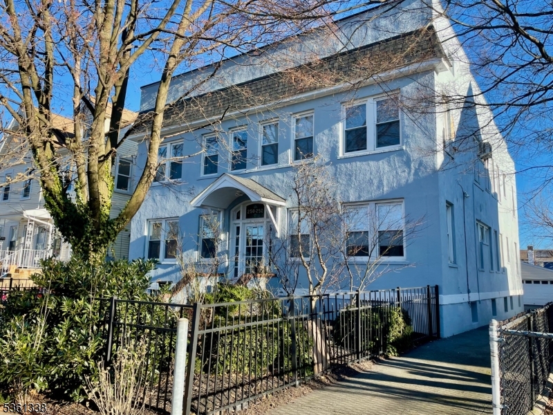 Front of property showcasing driveway, which includes one parking spot
