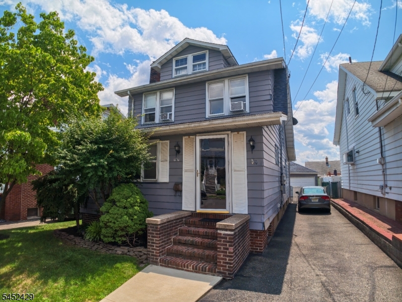 Charming side-hall Colonial with private driveway and inviting curb appeal.