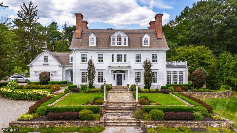 Beautifully situated this home proudly sits on a multi-tiered level lot with stone walls and perennial beds reminiscent of an era gone by..