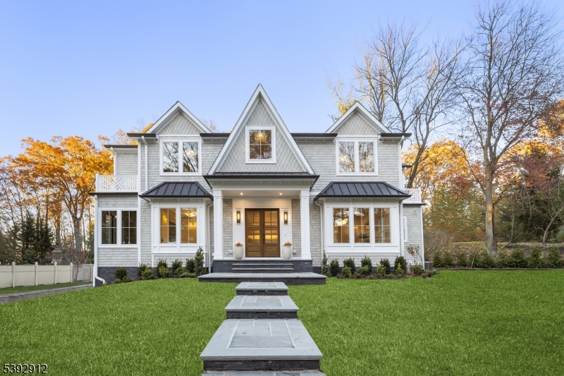 Architectural Marvel Architectural elegance meets modern craftsmanship. The striking facade welcomes you with NuCedar siding, Azek trim, standing seam metal accents, and a grand double-door entry that hints at the refined design and meticulous detail within