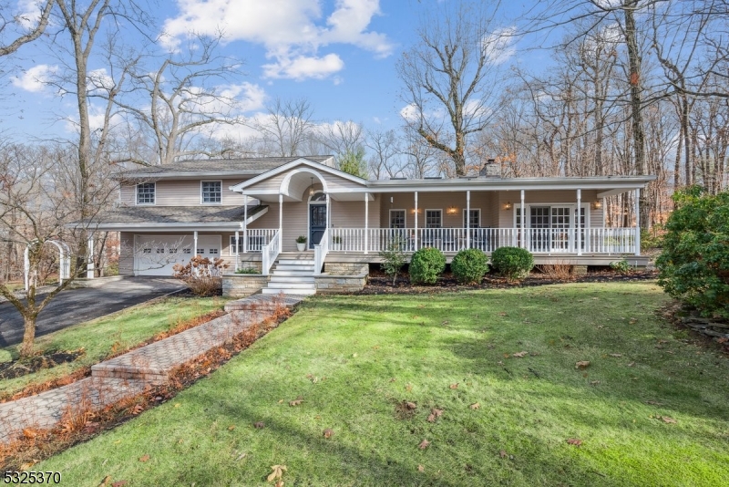 This home feature classic design elements, such as a charming front porch, dormer windows, and a neutral color palette that blends well with the natural surroundings.