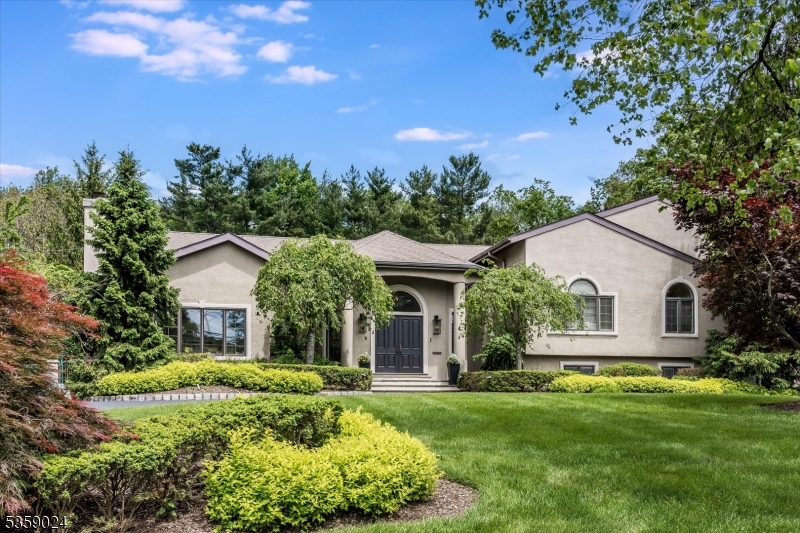 22 Ross Road is an architecturally distinctive custom home set on a lush, .80-acre lot in Livingston's prestigious Chestnut Hill neighborhood. A circular driveway, manicured landscaping, and grand double-door entry create an inviting first impression.