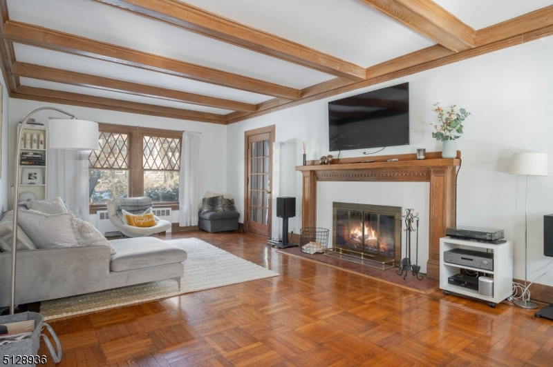 Beautiful LR Door to 3 season porch, decorative fireplace, gleaming wood floors, beamed ceiling. From previous listing.