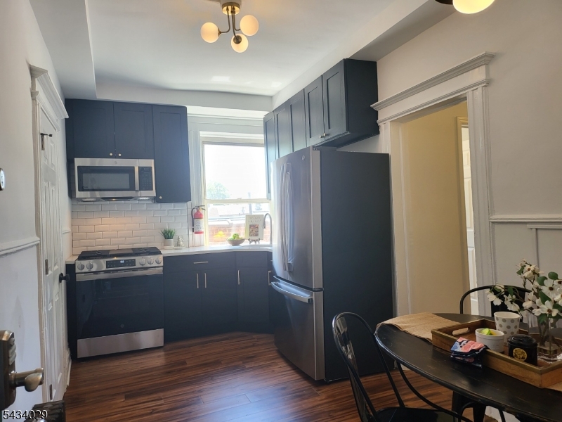 Deep Expresso Cabinets Eat in Kitchen with chic lighting