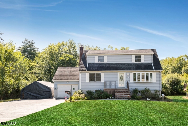On .57 acres of lush, green property, find this adorable Cape Cod home.