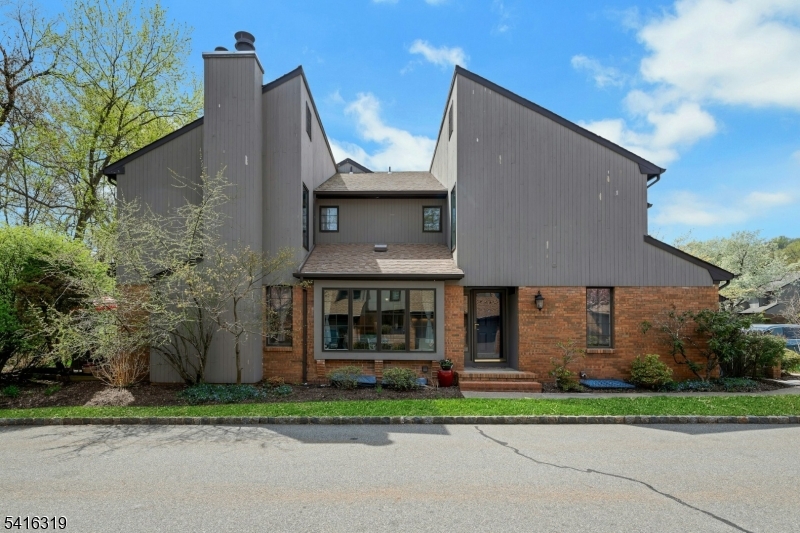The front door of this 3 bedroom end unit faces Keats Way and backs up to Spring Brook Golf Course