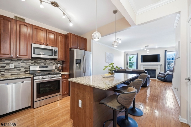 Custom Wood Cabinets, Center Island, Sleek granite Counters, Stainless Appliances, Pantry & Designer Fixtures